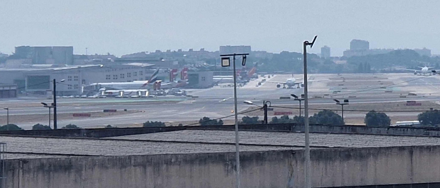 Aircraft at Lisbon Airport, with the city in the background